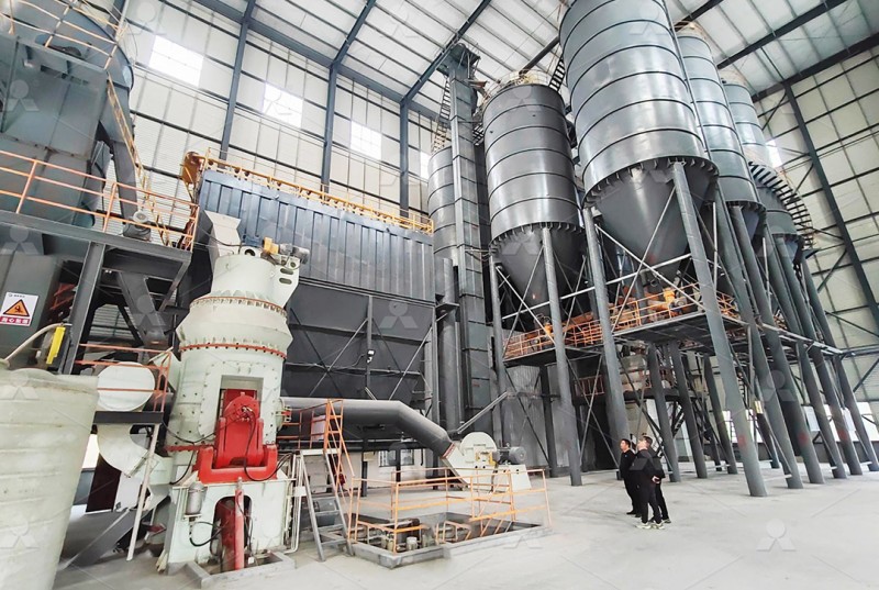 Modern control room operator monitoring the automated systems of a vertical grinding mill