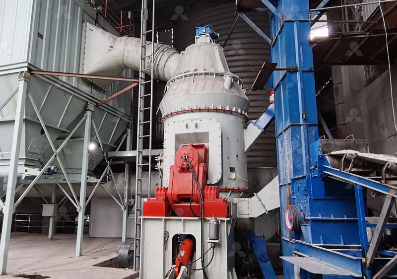 Calcium hydroxide digestion slag being fed into a grinding mill hopper