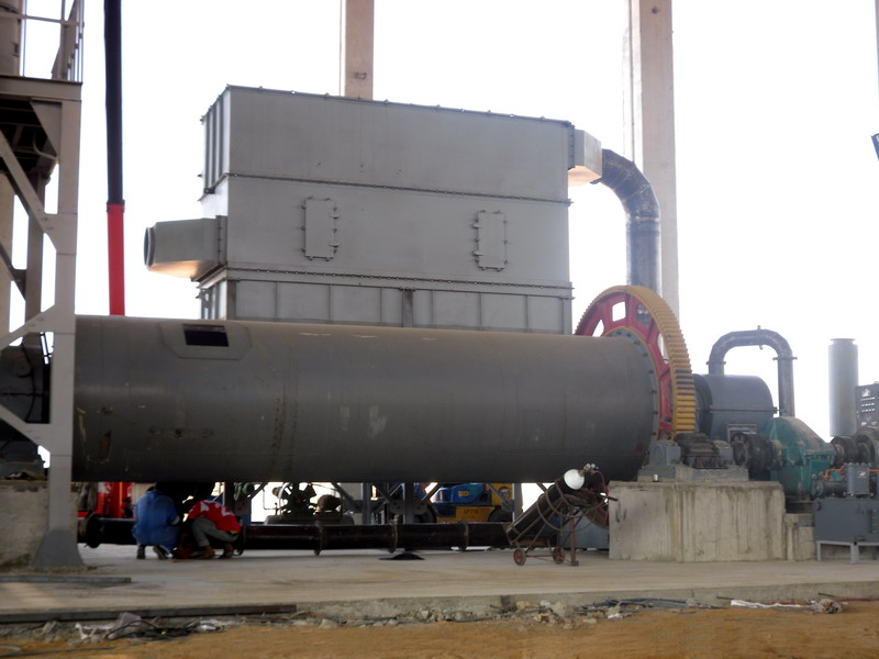 Industrial wet ball mill in operation showing slurry flow