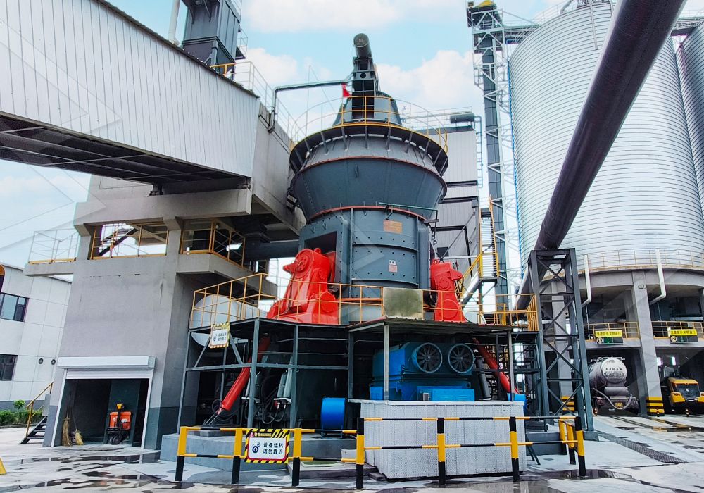 Interior view of a coal grinding mill showing rollers and grinding table