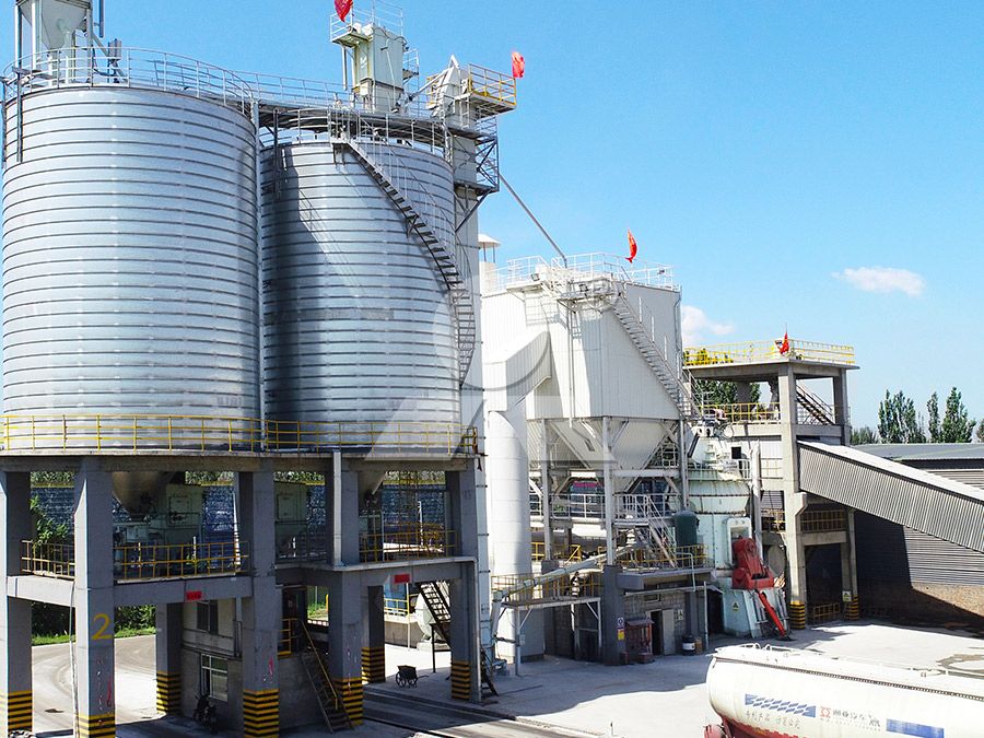 A modern industrial plant processing coal ash and slag with grinding mills in the background.