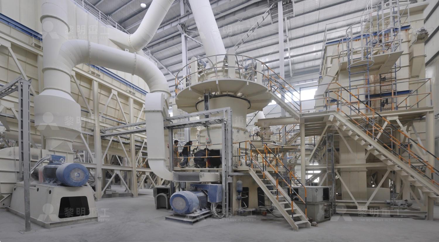 Industrial Raymond mill system overview showing the main grinding unit, classifier, and dust collection system in a factory setting