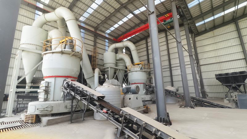 Technician inspecting the grinding roller assembly of a vertical mill during routine maintenance